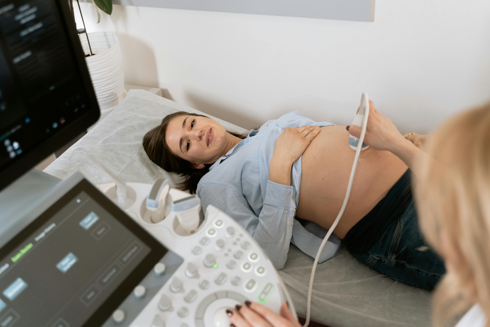 A modern, comfortable, and private ultrasound room setup at Athena Women's Clinic in Perth, prepared for a pregnancy and pelvic scan.